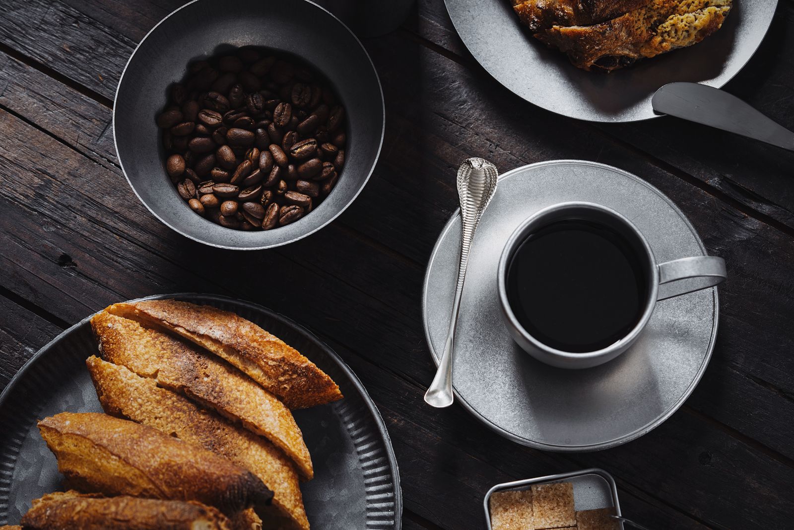A top view of coffee with pastries and coffee beans, perfect for cozy morning vibes.